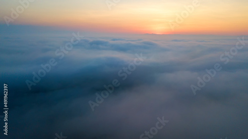 Passengers commercial airplane flying above clouds, detailed view of wing. Concept of fast modern travel
