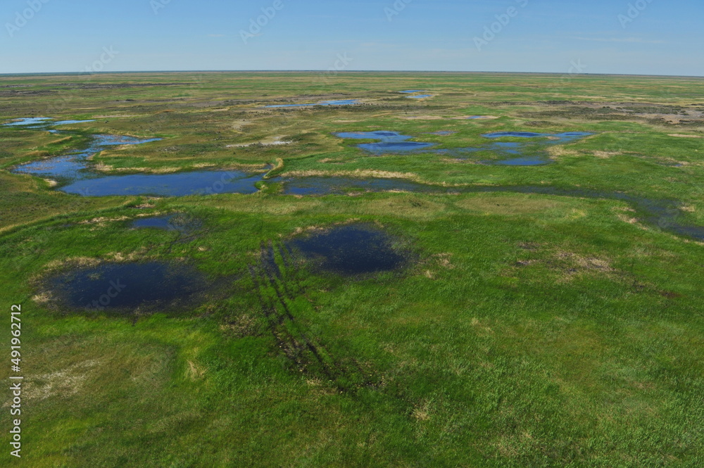 Zhambyl region, Kazakhstan - 05.17.2013 : An open valley with a riverbed and different vegetation for grazing animals