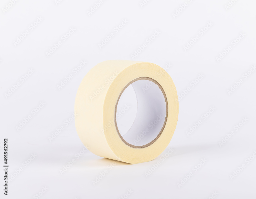 masking tape stands on a white background. adhesive paint protection tape. Painters and people who paint use this material.