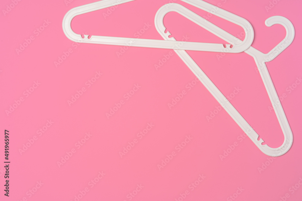 Flat lay composition with empty hangers on pink background Flat lay composition with empty hangers on pink background