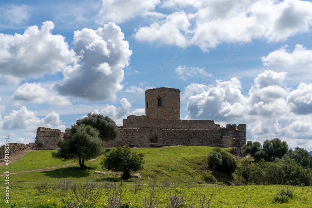 view of the castle of Jimena de la Frontera under an expressive sky