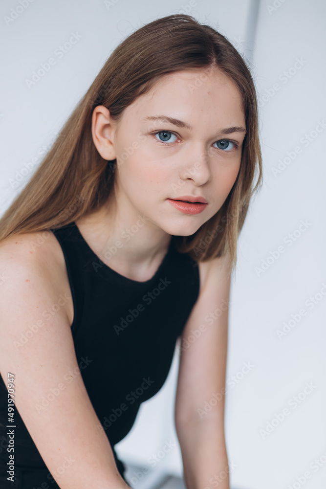 Blondie woman portrait. Model photosession on white background. Fashionable girl in black sport clothes Blondie woman portrait. Model photosession on white background. Fashionable girl in black sport clothes