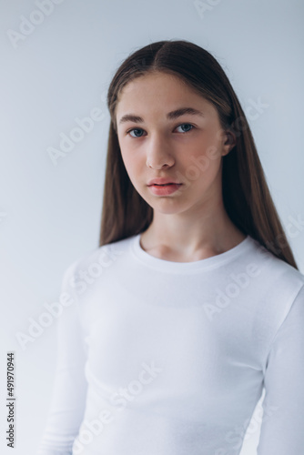 Blondie woman portrait. Model photosession on white background. Fashionable girl in black sport clothes 