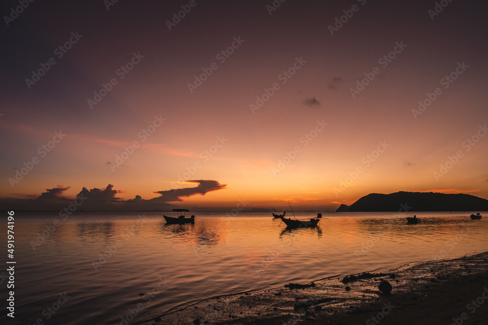 Silhouettes of fishing boats on the sea at a beautiful sunset Silhouettes of fishing boats on the sea at a beautiful sunset