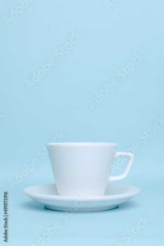 Plain white ceramic cup for mockup isolated on pastel blue background
