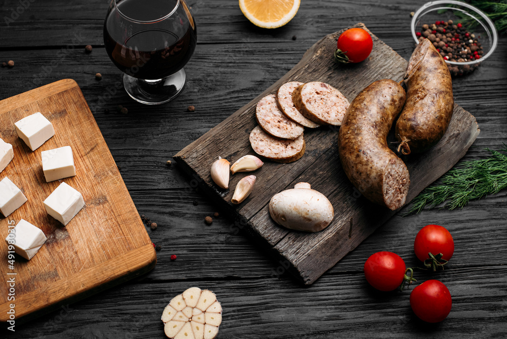 smoked homemade sausage on a wooden background and an old wooden hot smoked sausage