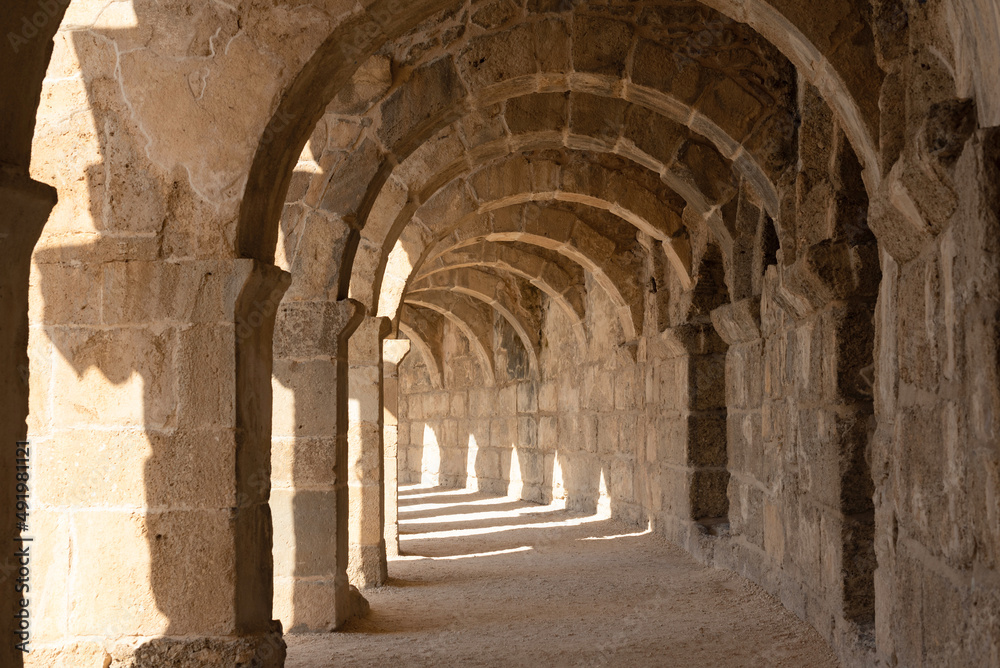 Light and shadow in ancient building with many arches in it