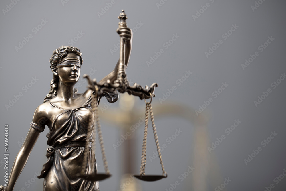 Law and justice concept. War crimes. Gavel, Themis sculpture and scale in lawyers office. Gray background. Law and justice concept. War crimes. Gavel, Themis sculpture and scale in lawyers office. Gray background.