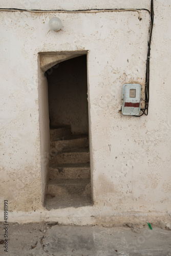  characteristic entrance to a building in Greece, narrow door and steep stone steps © Slawek