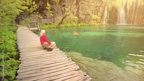 Woman in the jetty of Milino Jezero lake of Plitvice Lakes National Park in Croatia in the Lika region. UNESCO World Heritage of Croatia named Plitvicka Jezera. photo