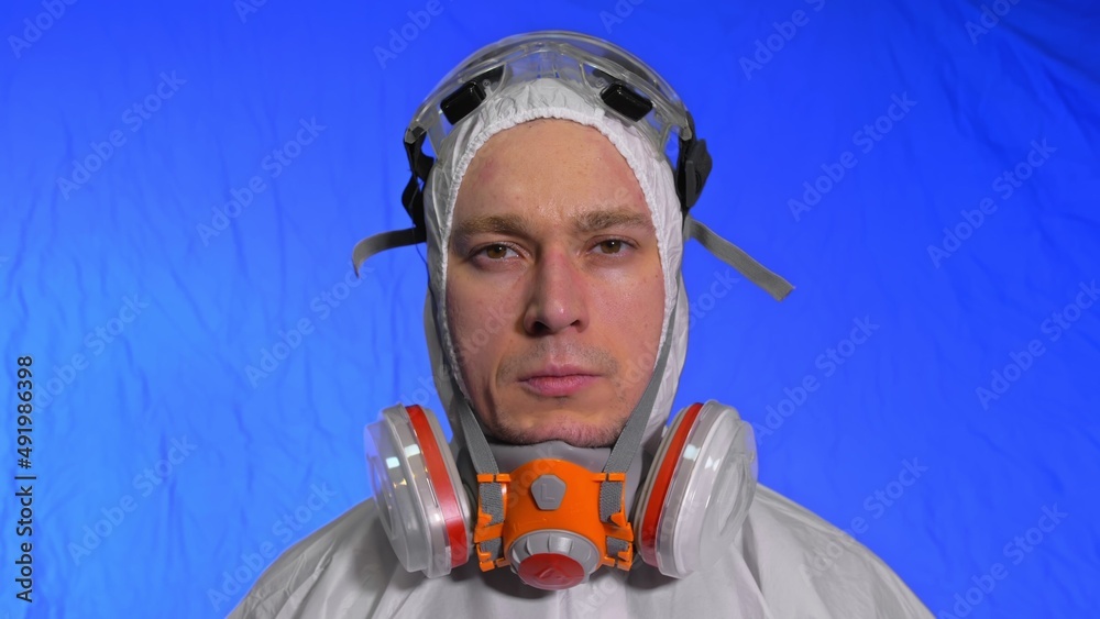 Scientist virologist in respirator. Slow motion. Man close up look, wearing protective medical mask. Concept health safety N1H1 virus protection coronavirus epidemic 2019 nCoV. Chroma key blue film. Scientist virologist in respirator. Slow motion. Man close up look, wearing protective medical mask. Concept health safety N1H1 virus protection coronavirus epidemic 2019 nCoV. Chroma key blue film.