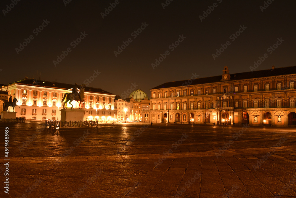 Night view of Plebiscito square in the center of Naples, Italian city. Important buildings from different historical periods overlook the circular square.