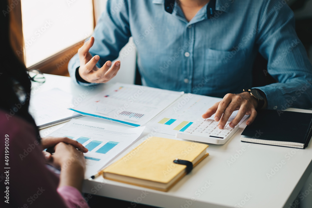 Meeting business team advisor about financial graph chart showing results are analyzing and calculating with calculator planning strategy Meeting business team advisor about financial graph chart showing results are analyzing and calculating with calculator planning strategy