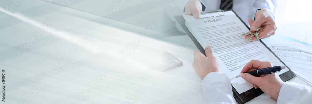 Client signing a real estate contract; panoramic banner Client signing a real estate contract; panoramic banner