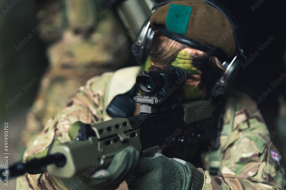 Sturdy strong grip holding a automatic smg during training as a rookie soldier . High quality photo