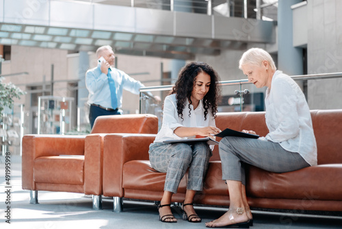 two business women discussing the terms of a new contract.