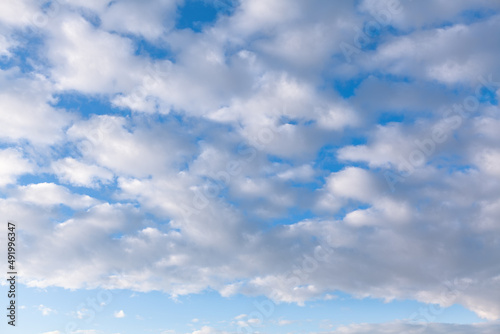 Stratocumulus white clouds at blue sky 