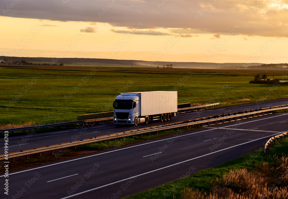 Freight truck. Truck with semi-trailer driving along highway. Goods delivery by roads. Services and Transport logistics. Lorry on delivery. Long Self-driving lorries. Shipping freight logistics.