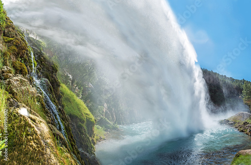 Montanejos, Valencia, Spain: 06.24.2021; The view of waterfall in  Montanejos with green plants photo