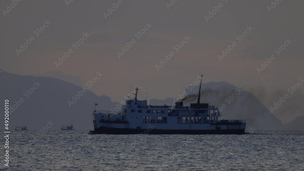 Ferry emitting black plumes while passing through the shot - Koh Samui island - Thailand Ferry emitting black plumes while passing through the shot - Koh Samui island - Thailand