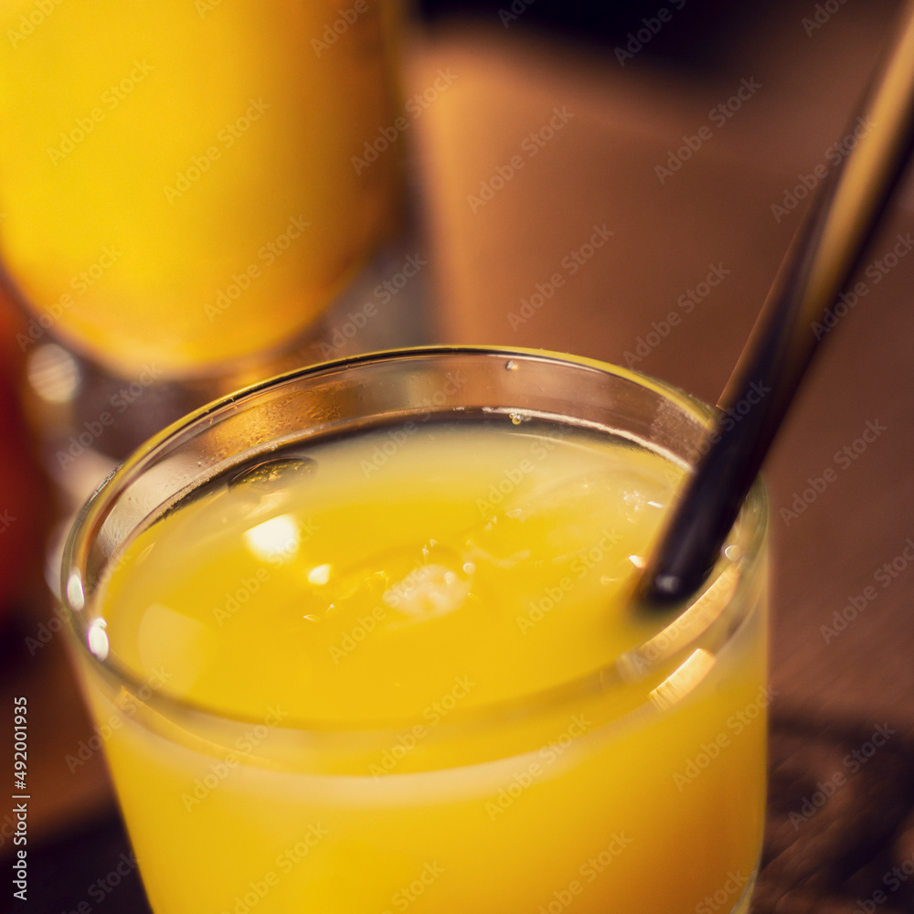 glass with fresh orange juice on wooden table close up square glass with fresh orange juice on wooden table close up square