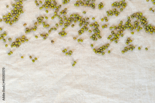 unpeeled mung bean on linen fabric background