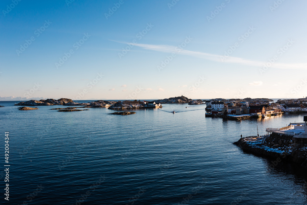 Fototapeta premium sunset over the sea - Lofoten, Norway - beautiful coast, snow-covered rocks