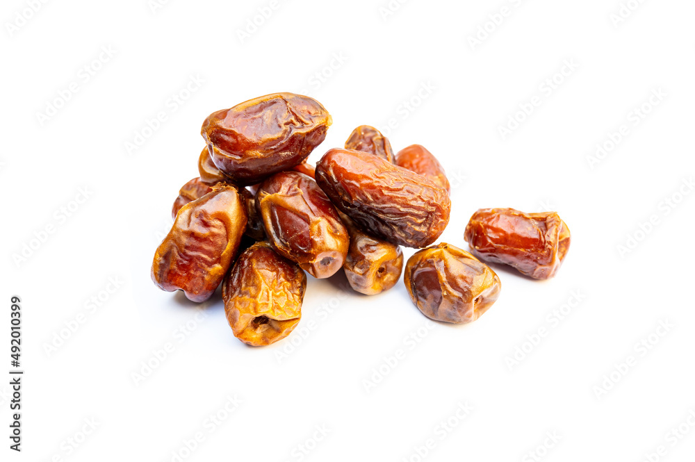 Bunch of dates close up.Pile of tasty dry dates isolated on white background. Arabic food Bunch of dates close up.Pile of tasty dry dates isolated on white background. Arabic food