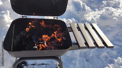 gorenje charcoal in the grill in winter. Preparation of coals for cooking on the grill.