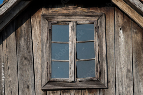 Sunja, Croatia, April 20,2021 : Rustic style aged window at rural home wall.