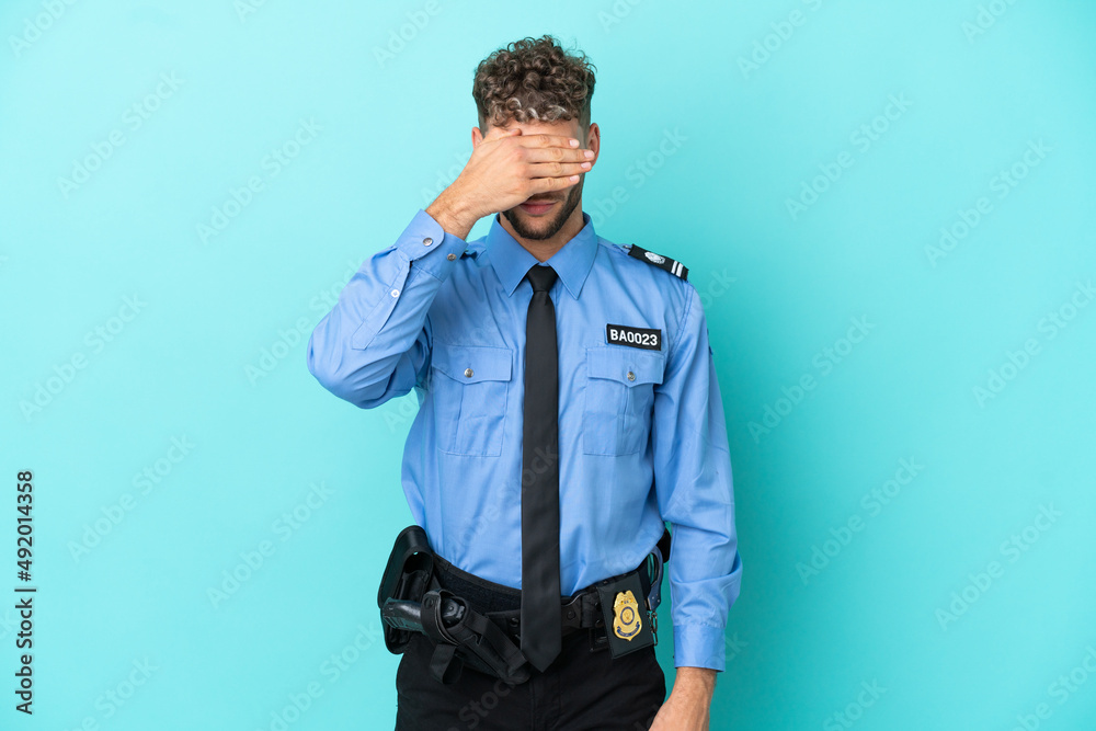 Young police blonde man isolated white on blue background covering eyes by hands. Do not want to see something Young police blonde man isolated white on blue background covering eyes by hands. Do not want to see something