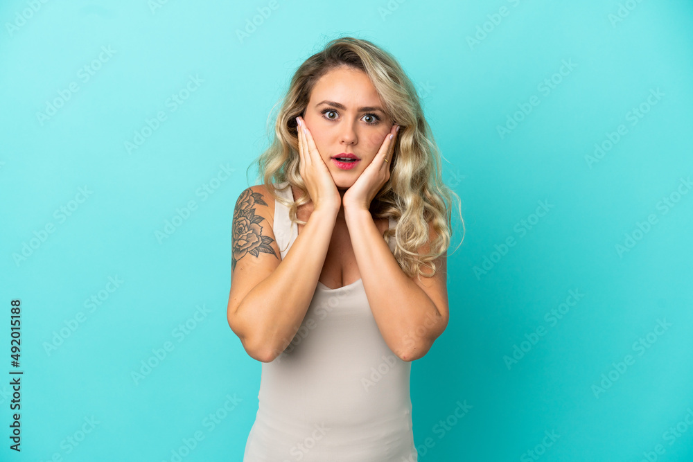 Young Brazilian woman isolated on blue background frustrated and covering ears