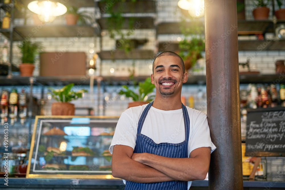 © Nola Viglietti/peopleimages.com - Customers always stop by for some quality service. Portrait of a young entrepreneur standing in his business.