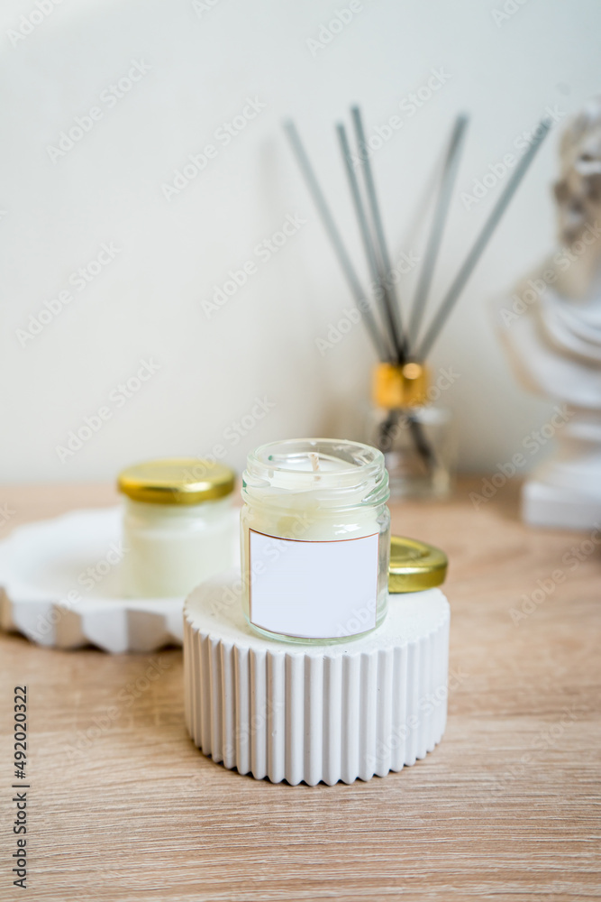 Elegant home decoration with wooden wick burning candle with label mock up Elegant home decoration with wooden wick burning candle with label mock up