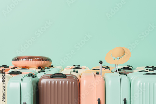 many suitcases stacked with summer travel accessories photo