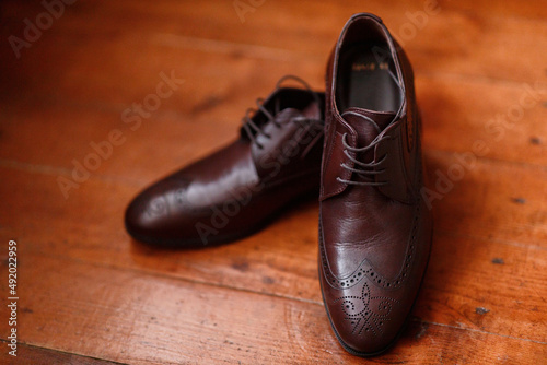 brown leather italian classic shoes close-up on wooden parquet