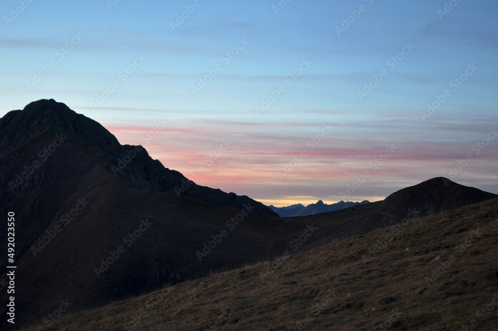 Sunset and Mountain Silhouette. Zambla Alta, Italy