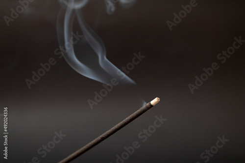incense smoking stick on a black background
