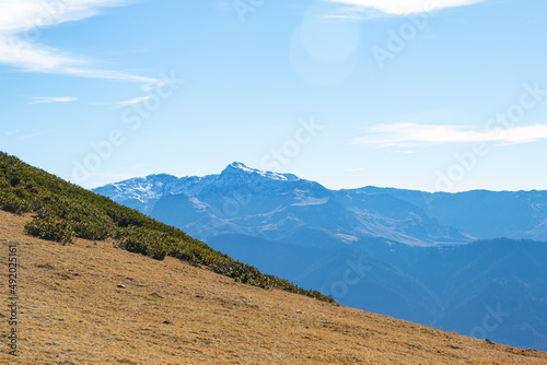 Mountain landscapes with peaks and valleys with plants and blue sky. A sunny day is good for a trip to the mountains and adventures