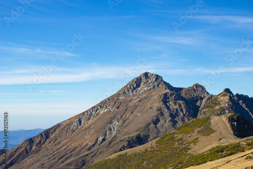 Mountain landscapes with peaks and valleys with plants and blue sky. A sunny day is good for a trip to the mountains and adventures