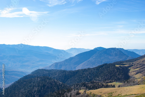 Mountain landscapes with peaks and valleys with plants and blue sky. A sunny day is good for a trip to the mountains and adventures