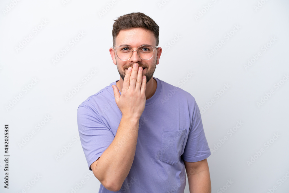 Young caucasian man isolated on white background happy and smiling covering mouth with hand Young caucasian man isolated on white background happy and smiling covering mouth with hand