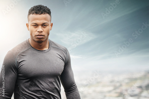 Get out there and get fit. Portrait of a sporty young man exercising outdoors.