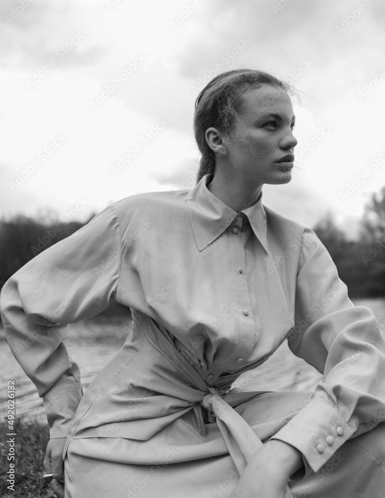 Fototapeta premium Fashion portrait of a beautiful and cute girl in nature in stylish clothes