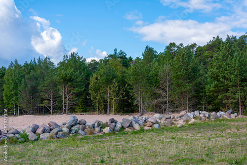 The stone embankment is part of the old wharf on the pier of the Konevetsky monastery photo