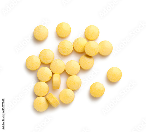 Yellow pills on white backg...