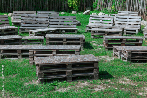 Wooden seats on the grass . Outdoor benches at nature