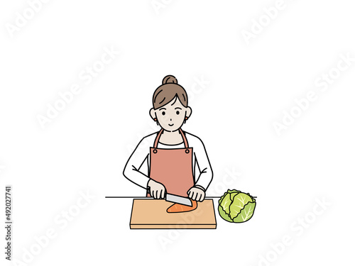 料理　野菜を切る主婦　エプロン姿の女性　イラスト