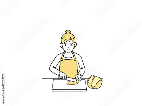 料理　野菜を切る主婦　エプロン姿の女性　イラスト