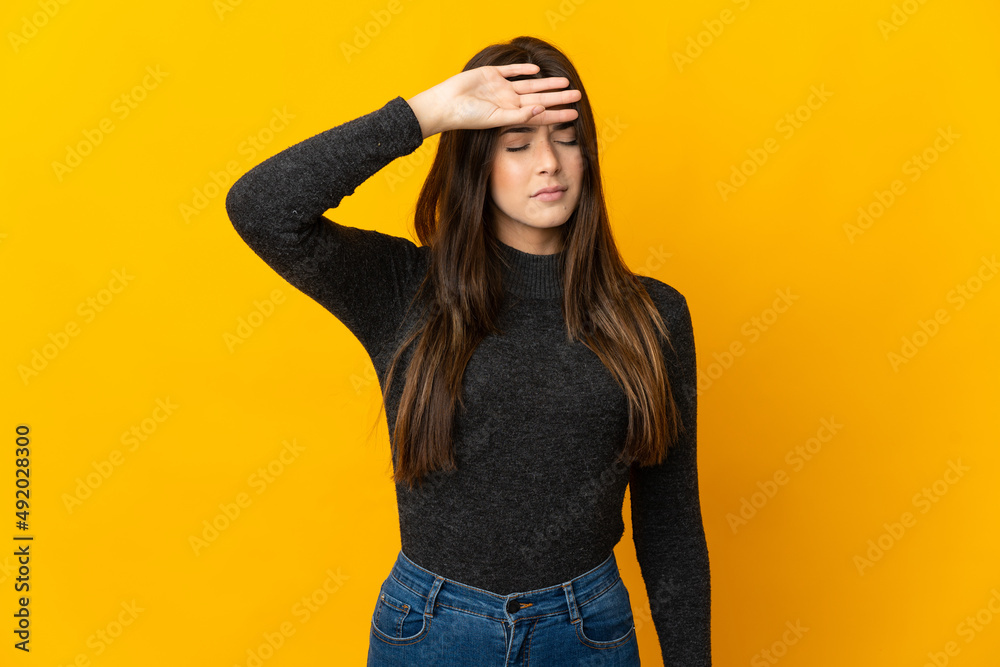 Teenager Brazilian girl isolated on yellow background with tired and sick expression Teenager Brazilian girl isolated on yellow background with tired and sick expression
